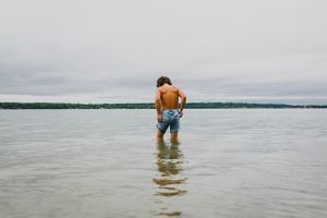 boy-dips-legs-into-lake-simoe