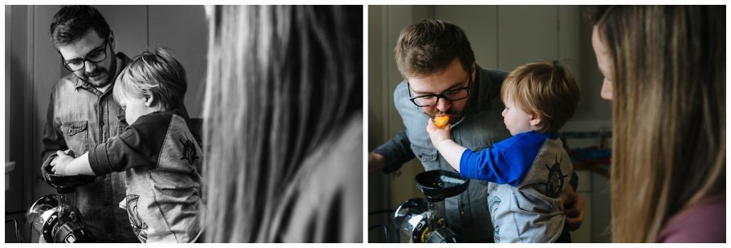 little-boy-shares-orange-slices-with-dad-while-they-make-juice-together-in-their-kitchen