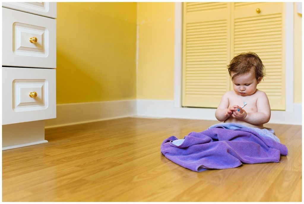 little-boy-in-purple-towel-attempts-to-brush-his-own-teeth