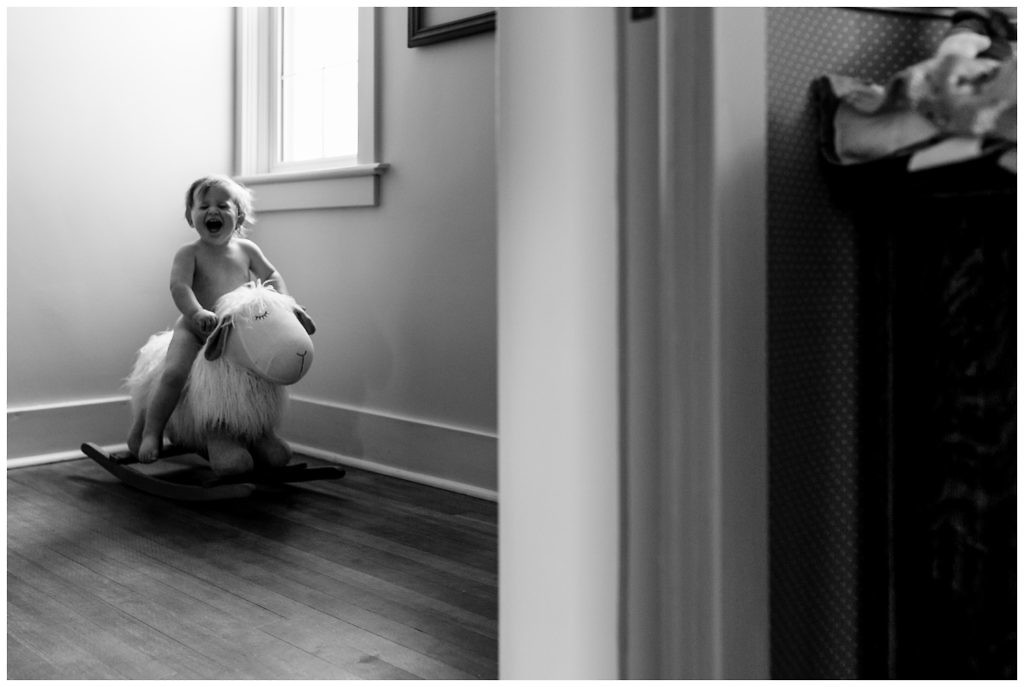 little-boy-laughs-hysterically-while-riding-a-lamb-rocker