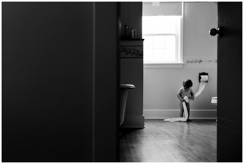 little-boy-pulls-toilet-paper-off-of-the-roll-making-a-mess