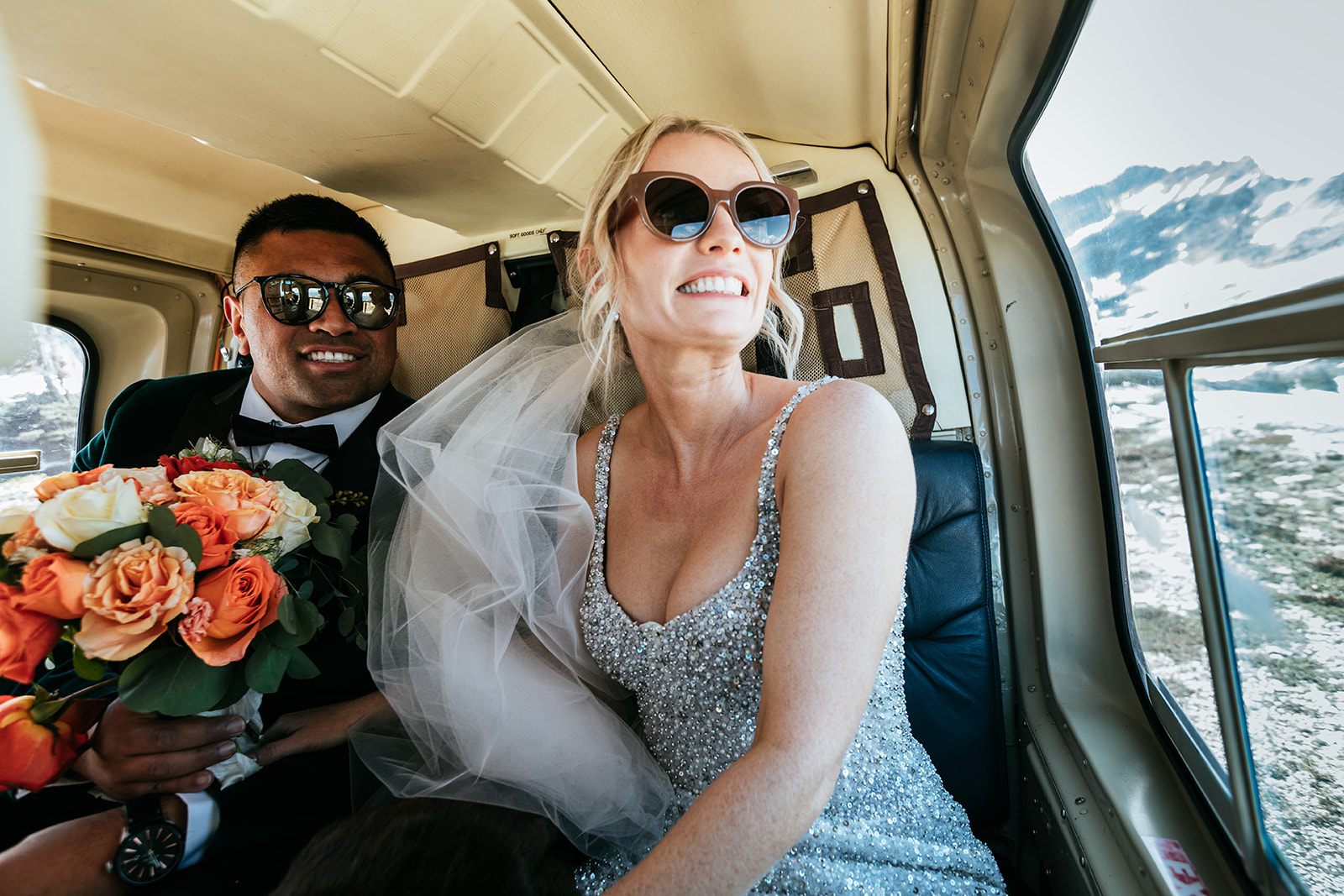 bride-and-groom-flying-in-helicopter-with-glacier-helicopters-revelstoke-going-to-mount-begbie-for-their-mountain-elopement