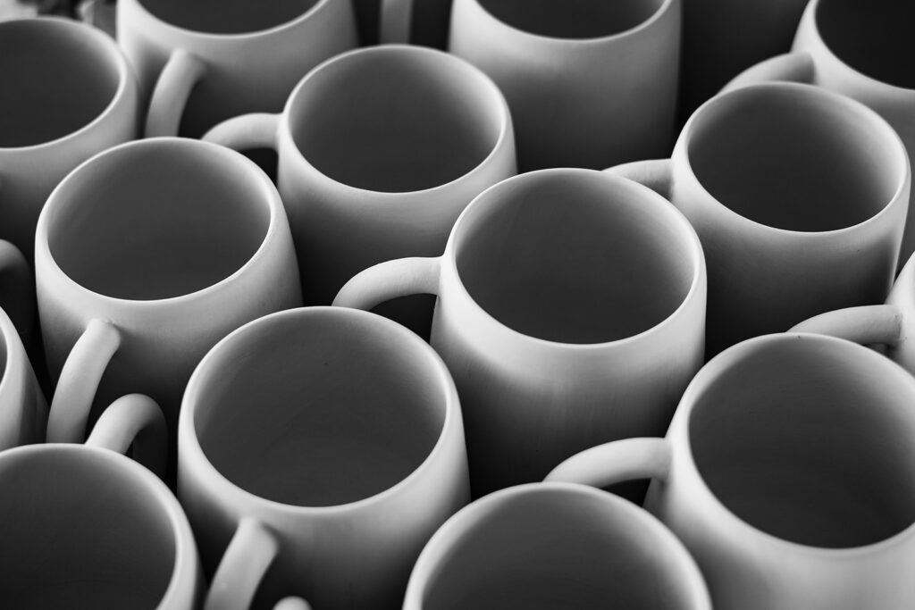 black-white-photograph-hand-thrown-mugs-waiting-to-be-fired-kil